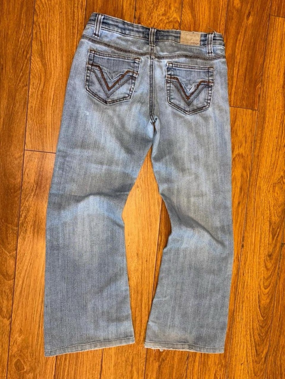 Y2K 2000s baggy denim jeans with embroidered design and natural wear